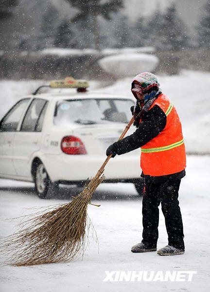 12月3日,在海拉尔街头,一位环卫工人正在扫雪.新华社记者 任军川摄